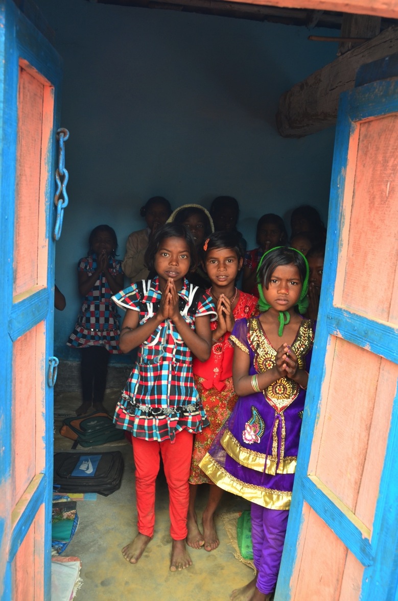 School children gathered in a blue classroom doorway